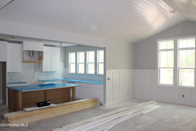 3359 Portside Dr SW, Supply, NC 28462 - kitchen featuring white cabinetry, vaulted ceiling, wainscoting, and modern cabinets