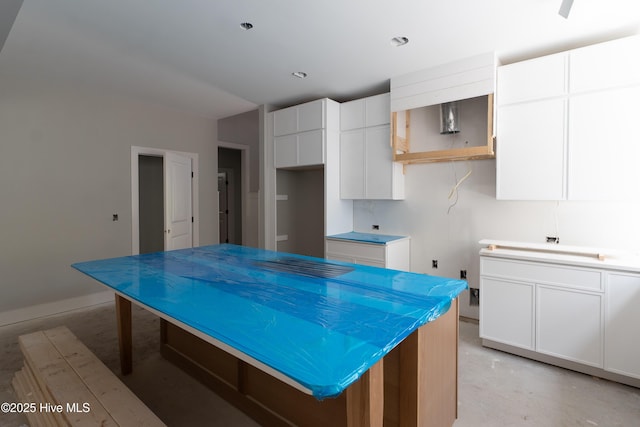 3359 Portside Dr SW, Supply, NC 28462 - kitchen with white cabinets, concrete floors, and baseboards