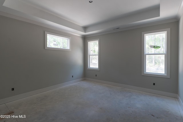 3359 Portside Dr SW, Supply, NC 28462 - spare room featuring a tray ceiling, unfinished concrete floors, healthy amount of natural light, and baseboards