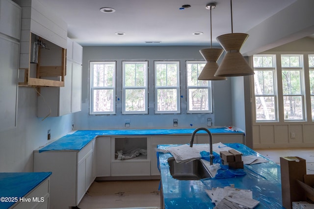 3359 Portside Dr SW, Supply, NC 28462 - kitchen featuring healthy amount of natural light and white cabinetry