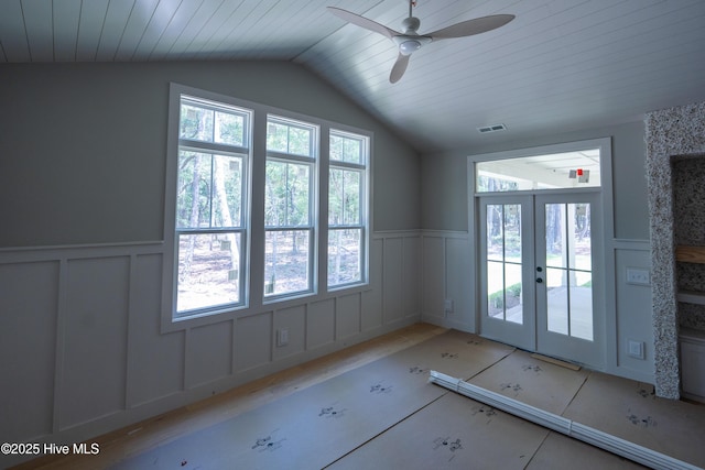 3359 Portside Dr SW, Supply, NC 28462 - empty room with lofted ceiling, a decorative wall, ceiling fan, wainscoting, and french doors