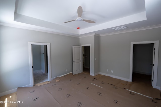 3359 Portside Dr SW, Supply, NC 28462 - unfurnished bedroom with a raised ceiling, a walk in closet, and a ceiling fan