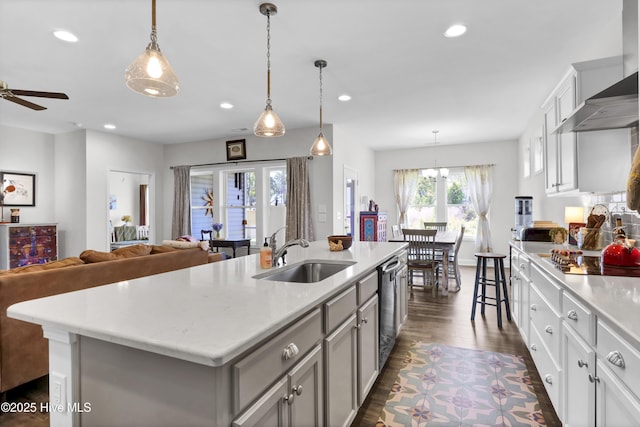 kitchen with open floor plan, a sink, light countertops, and black electric cooktop