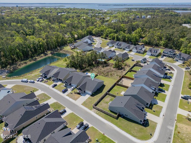 birds eye view of property featuring a water view and a residential view