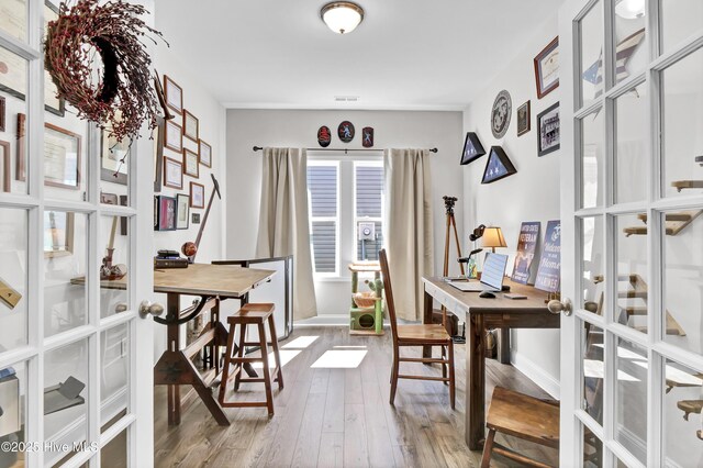 office space featuring wood finished floors, baseboards, and french doors