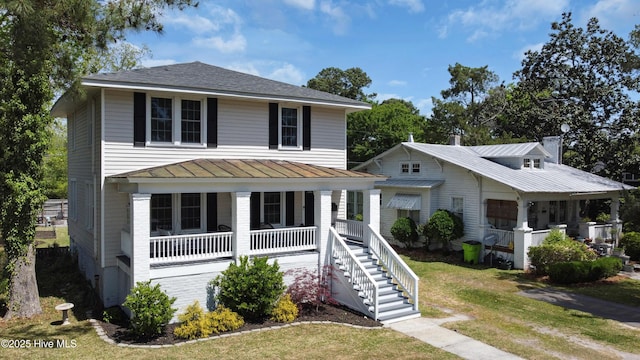 1508 Rhem Ave, New Bern, NC 28560 - view of front facade with a standing seam roof, stairway, metal roof, a front yard, and a porch