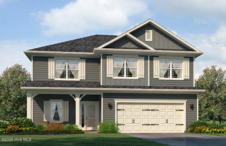 view of front of home with board and batten siding, an attached garage, driveway, and roof with shingles