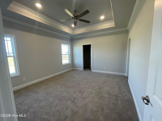 unfurnished bedroom with baseboards, a raised ceiling, ornamental molding, carpet, and recessed lighting