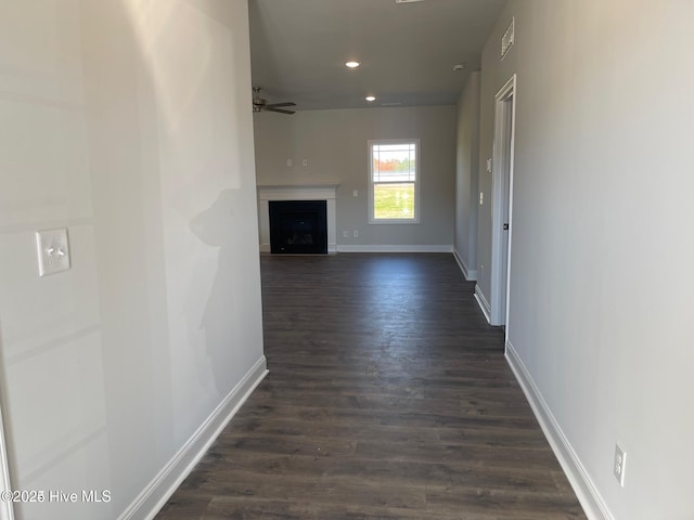 hall featuring recessed lighting, dark wood-style floors, baseboards, and visible vents