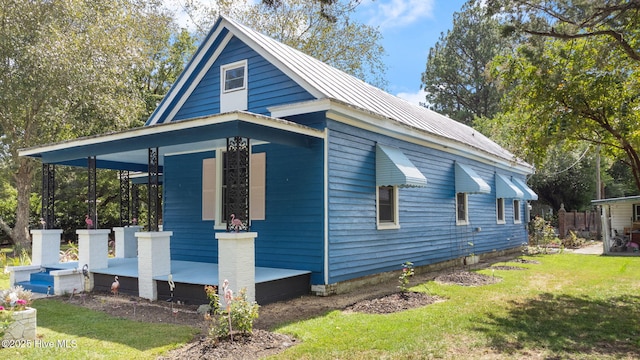 104 W Trent St, Trenton, NC 28585 - view of home's exterior featuring a yard, metal roof, and covered porch