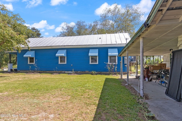 104 W Trent St, Trenton, NC 28585 - back of house featuring metal roof, a lawn, and a patio area