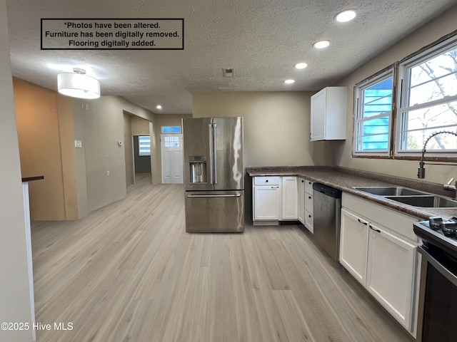 104 W Trent St, Trenton, NC 28585 - kitchen with appliances with stainless steel finishes, a textured ceiling, a sink, recessed lighting, and white cabinets