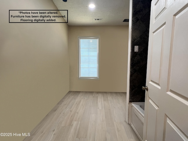104 W Trent St, Trenton, NC 28585 - corridor featuring light wood-type flooring and a textured ceiling