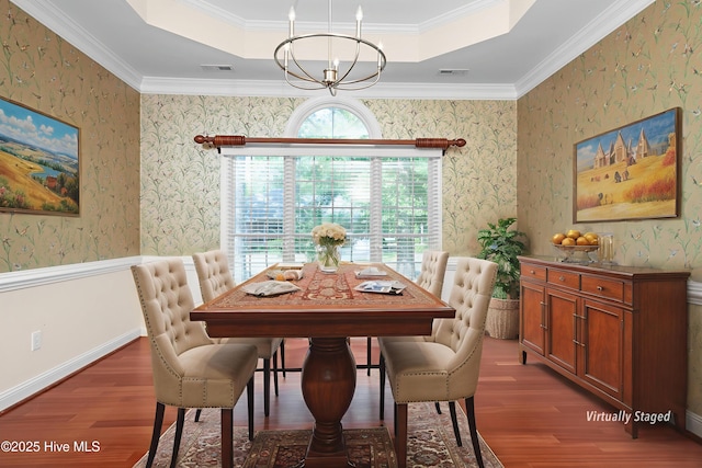 106 Oakmont Cir, New Bern, NC 28562 - dining room featuring a tray ceiling, wood finished floors, a chandelier, wallpapered walls, and ornamental molding