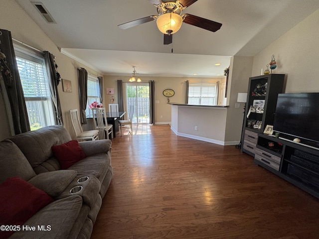 living room featuring crown molding, dark wood-style flooring, ceiling fan, baseboards, and visible vents