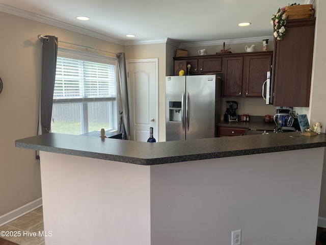 kitchen with ornamental molding, a peninsula, dark brown cabinetry, dark countertops, and appliances with stainless steel finishes