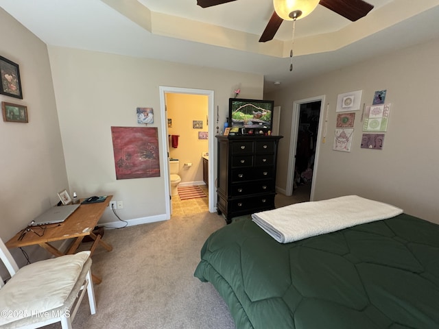 carpeted bedroom featuring ceiling fan, baseboards, ensuite bathroom, a spacious closet, and a closet