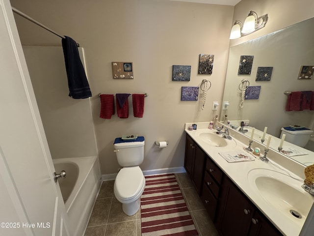 bathroom featuring toilet, a washtub, a sink, and tile patterned flooring