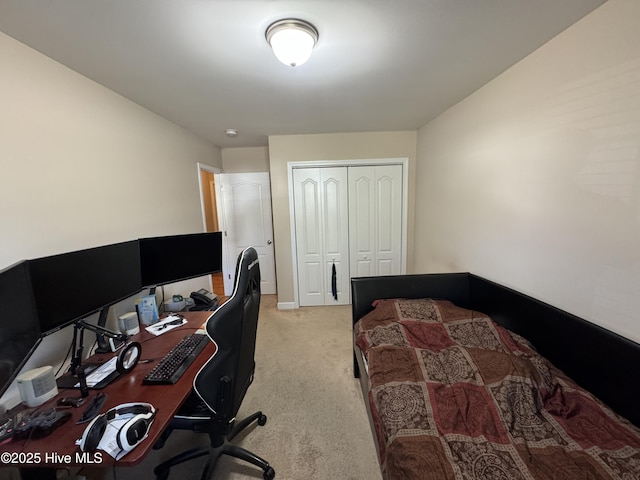 bedroom with a closet, baseboards, and light carpet