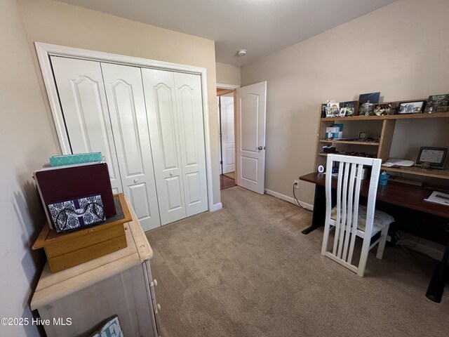 carpeted office featuring baseboards
