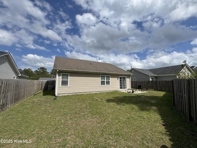 back of house with a lawn, a fenced backyard, and a patio area