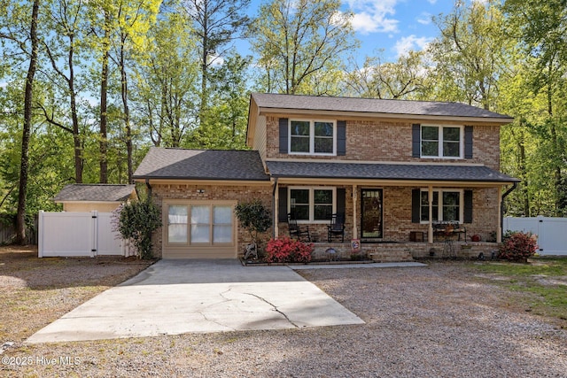 307 Little Rossie Rd, New Bern, NC 28560 - view of front facade featuring concrete driveway, an attached garage, a gate, and brick siding