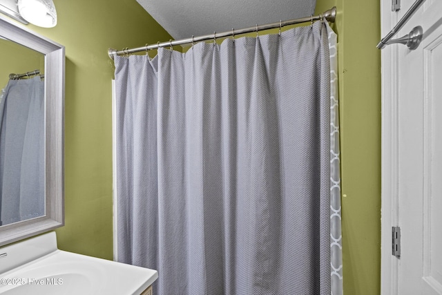 307 Little Rossie Rd, New Bern, NC 28560 - bathroom with a textured ceiling, vanity, and a shower with curtain