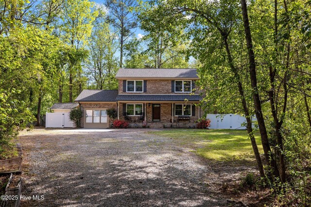 307 Little Rossie Rd, New Bern, NC 28560 - view of front facade with a gate, brick siding, fence, and driveway