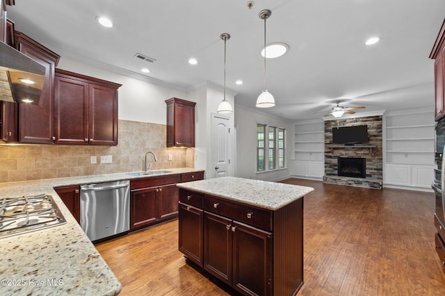 80 Whistling Straight Rd, Pinehurst, NC 28374 - kitchen featuring stainless steel appliances, open floor plan, a ceiling fan, ornamental molding, and a fireplace