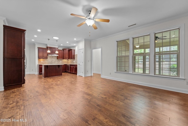 80 Whistling Straight Rd, Pinehurst, NC 28374 - unfurnished living room featuring ceiling fan, crown molding, dark wood-type flooring, and recessed lighting
