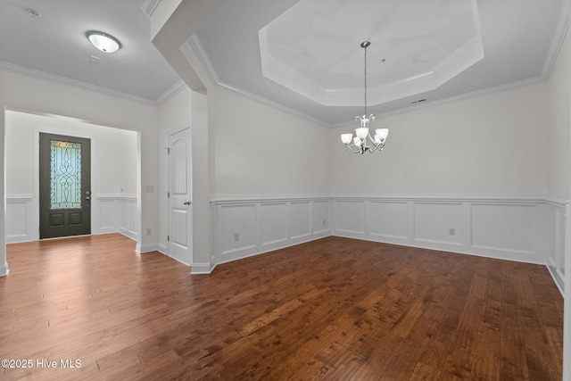 80 Whistling Straight Rd, Pinehurst, NC 28374 - unfurnished room featuring a chandelier, wood-type flooring, crown molding, a tray ceiling, and a decorative wall