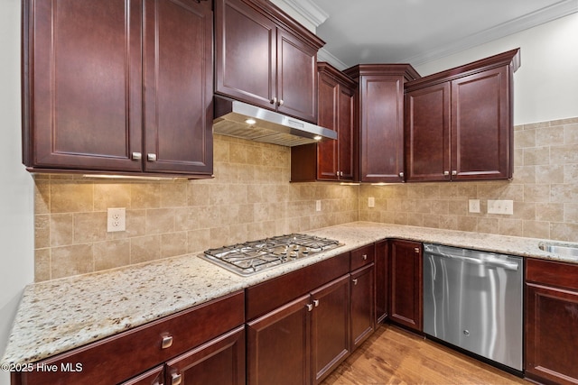 80 Whistling Straight Rd, Pinehurst, NC 28374 - kitchen featuring stainless steel appliances, under cabinet range hood, light stone countertops, dark brown cabinets, and ornamental molding