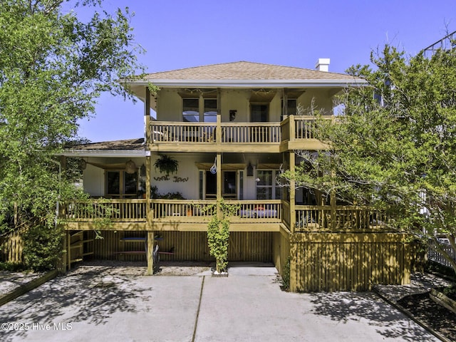 511 N Channel Dr, Wrightsville Beach, NC 28480 - back of house with a wooden deck, a balcony, and stucco siding