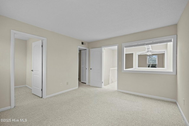 interior space featuring carpet floors, baseboards, and visible vents