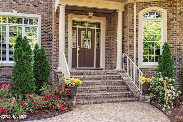 doorway to property featuring brick siding
