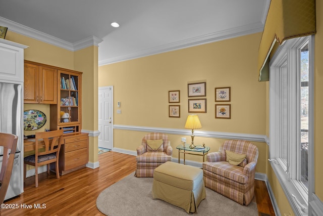sitting room featuring baseboards, ornamental molding, wood finished floors, and recessed lighting