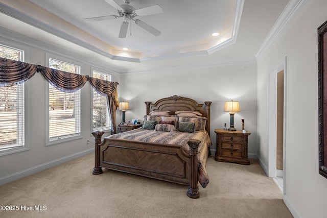 bedroom with light colored carpet, crown molding, a tray ceiling, and multiple windows