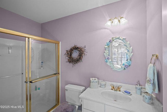 full bathroom with vanity, a stall shower, and toilet