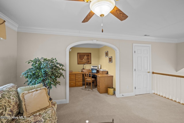 office featuring light colored carpet, ornamental molding, baseboards, and ceiling fan