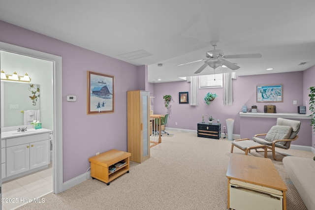 living area featuring light colored carpet, baseboards, and ceiling fan