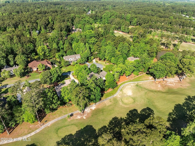 bird's eye view featuring a view of trees and golf course view