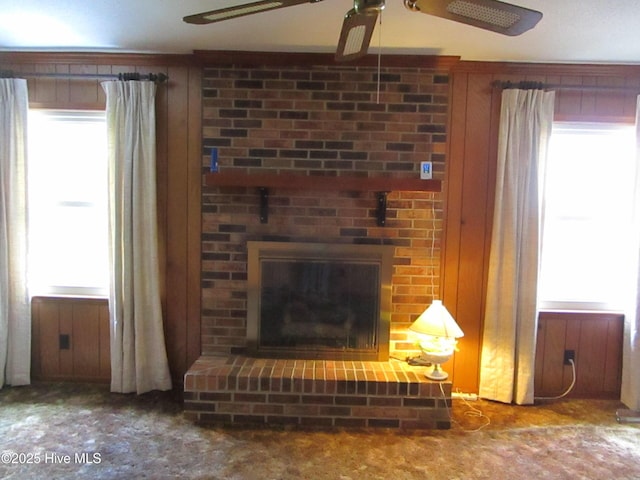 living room featuring a healthy amount of sunlight, a fireplace, and ceiling fan
