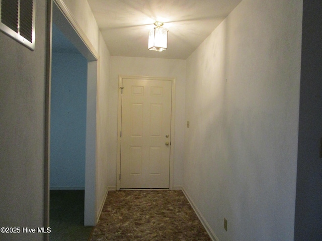 doorway featuring visible vents, baseboards, and stone finish flooring