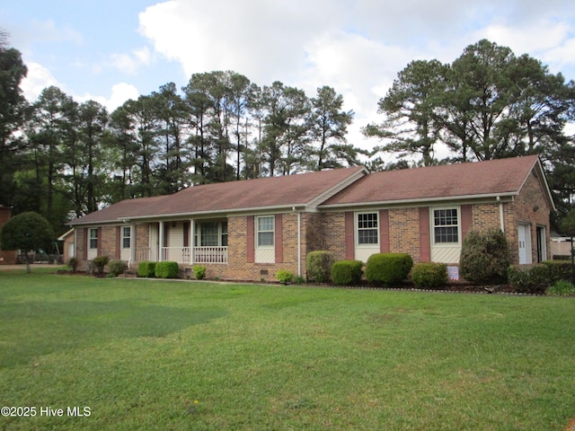 single story home featuring a porch, a front yard, and brick siding