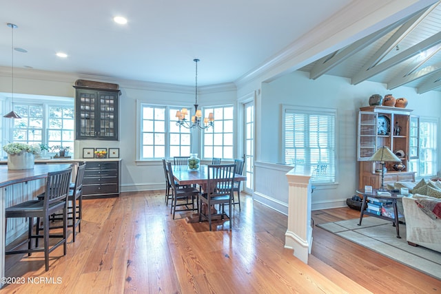 dining room with baseboards, ornamental molding, a chandelier, beamed ceiling, and wood finished floors