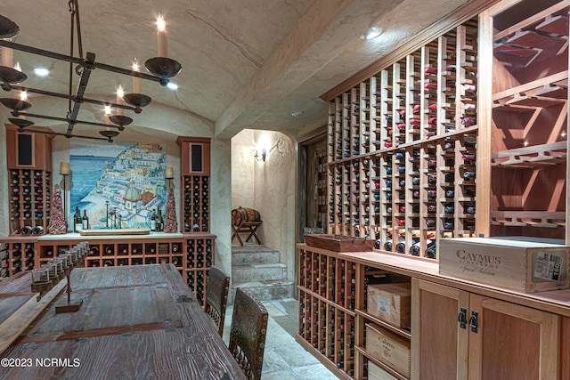 wine cellar featuring stone tile flooring and vaulted ceiling