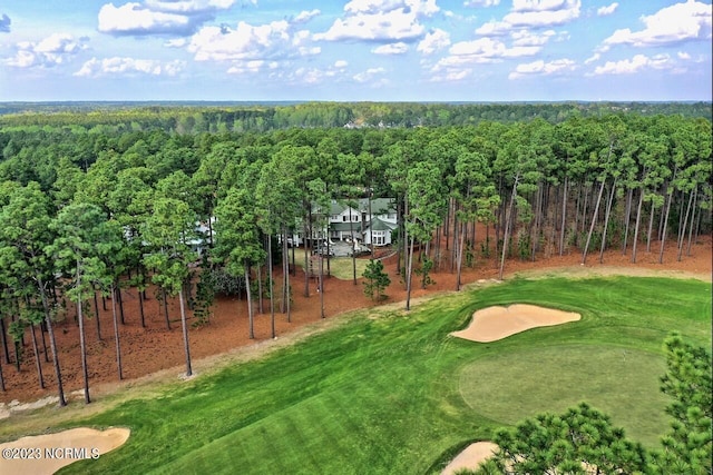 exterior space with golf course view and a forest view