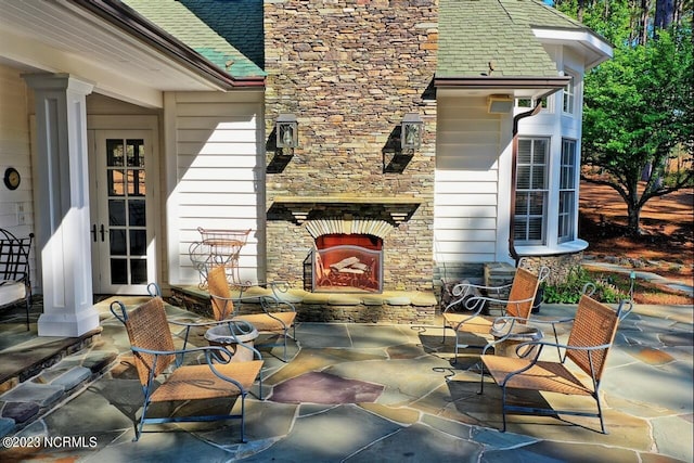 view of patio / terrace with an outdoor stone fireplace