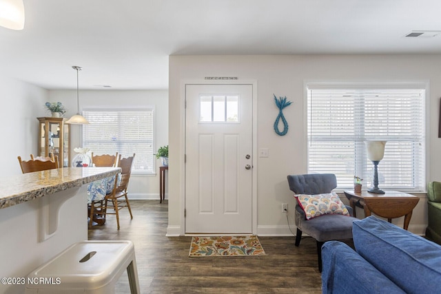 entrance foyer featuring visible vents, baseboards, and dark wood-style floors