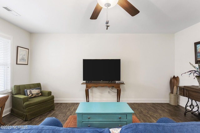 living room featuring wood finished floors, a healthy amount of sunlight, visible vents, a ceiling fan, and baseboards